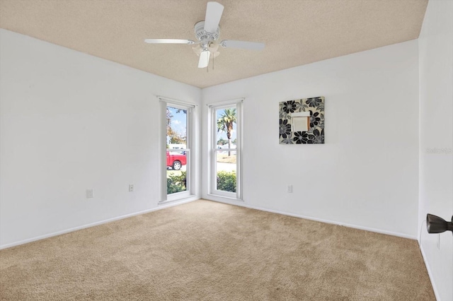 unfurnished room featuring a textured ceiling, ceiling fan, and carpet flooring