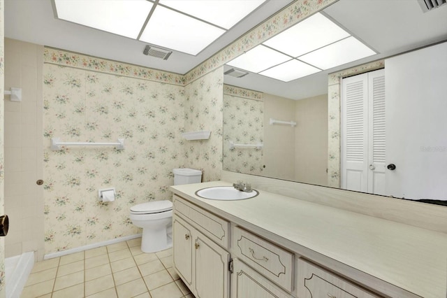 bathroom featuring tile patterned flooring, vanity, and toilet