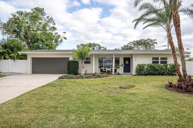 ranch-style home with a front lawn and a garage