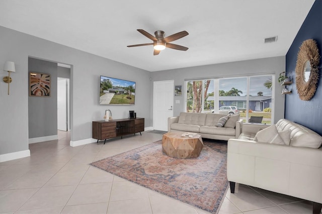 tiled living room with ceiling fan