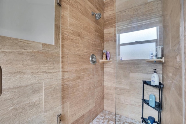 bathroom with a tile shower