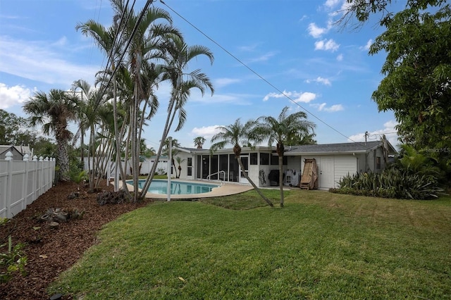 back of house with a patio area, a fenced in pool, and a lawn