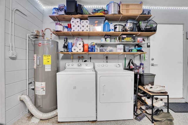 laundry area with washer and clothes dryer and water heater