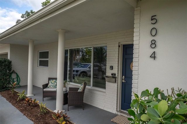 view of exterior entry with a porch