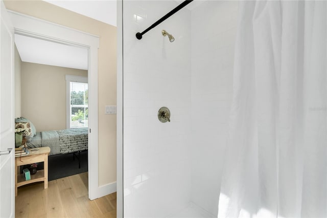 bathroom with hardwood / wood-style floors and a shower with curtain