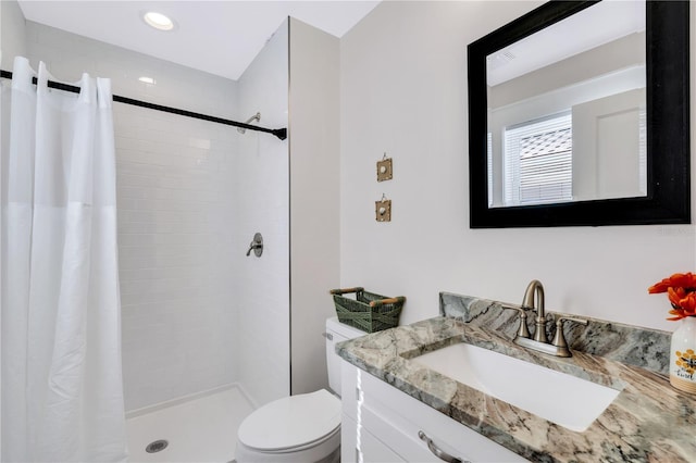 bathroom featuring toilet, a shower with shower curtain, and vanity