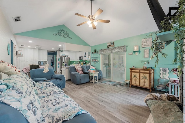 living room with ceiling fan, high vaulted ceiling, and light hardwood / wood-style flooring