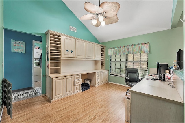 office space with ceiling fan, lofted ceiling, built in desk, and light wood-type flooring