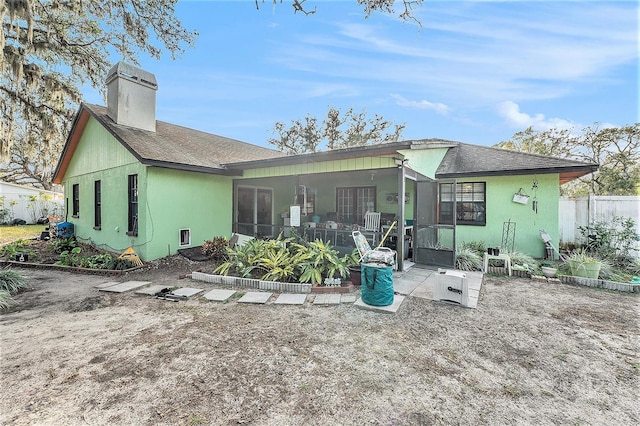 back of property featuring a sunroom