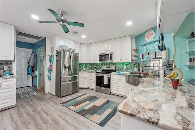 kitchen featuring sink, white cabinetry, and stainless steel appliances