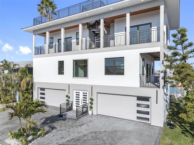 view of front of home featuring a garage and a balcony