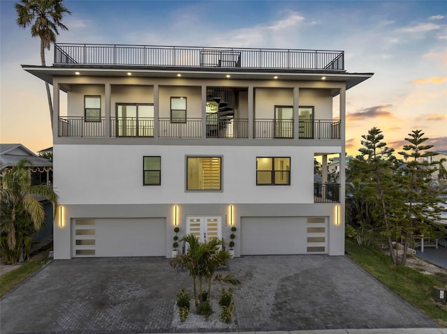 view of front of house featuring a balcony and a garage