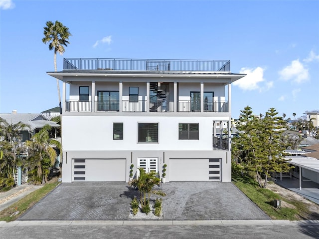 view of front facade featuring a garage and a balcony