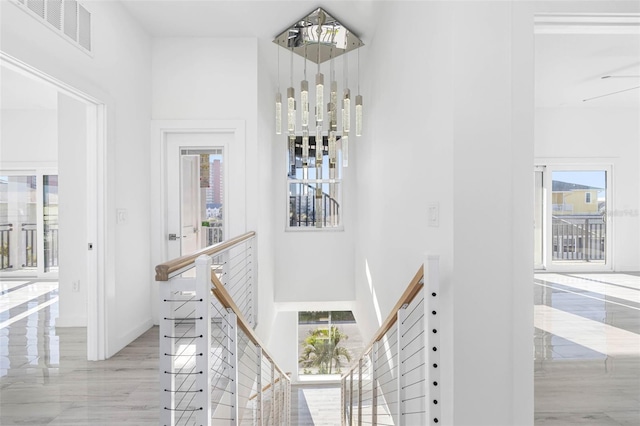 stairway with a healthy amount of sunlight and a high ceiling