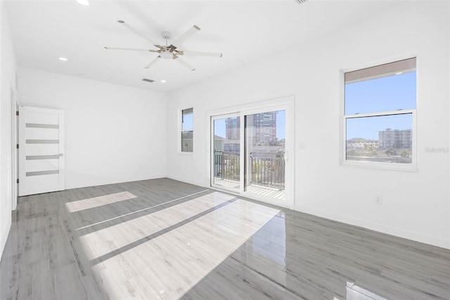 spare room with ceiling fan and hardwood / wood-style floors