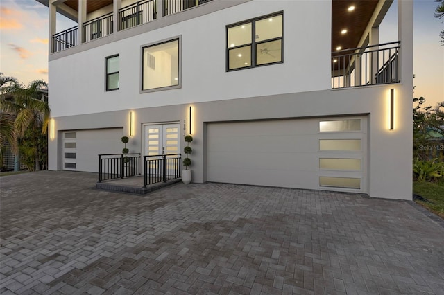 contemporary home with a garage and a balcony