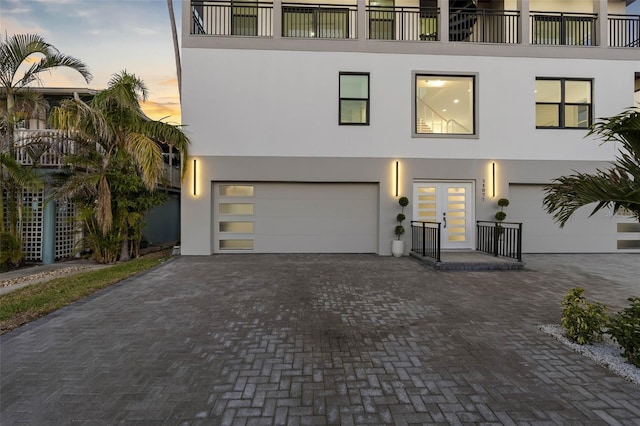 view of front facade with a garage and french doors