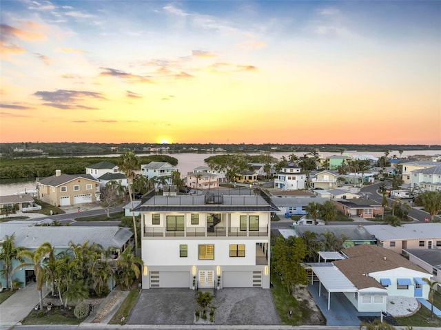 aerial view at dusk with a water view