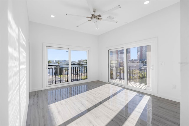 unfurnished room featuring ceiling fan and dark hardwood / wood-style floors