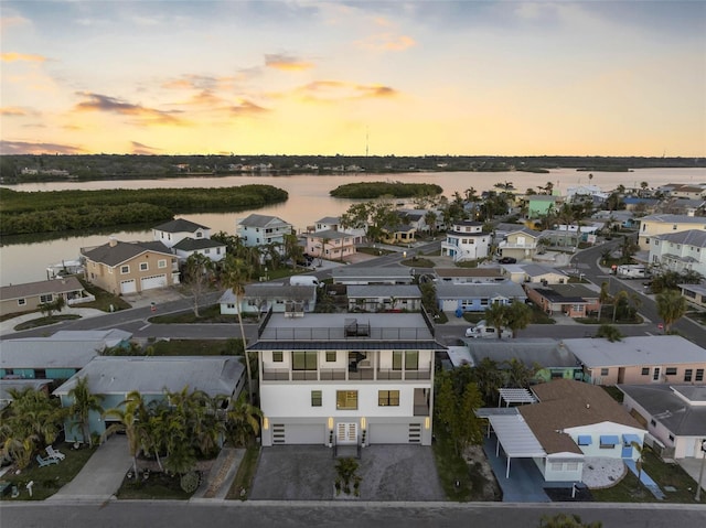 aerial view at dusk with a water view