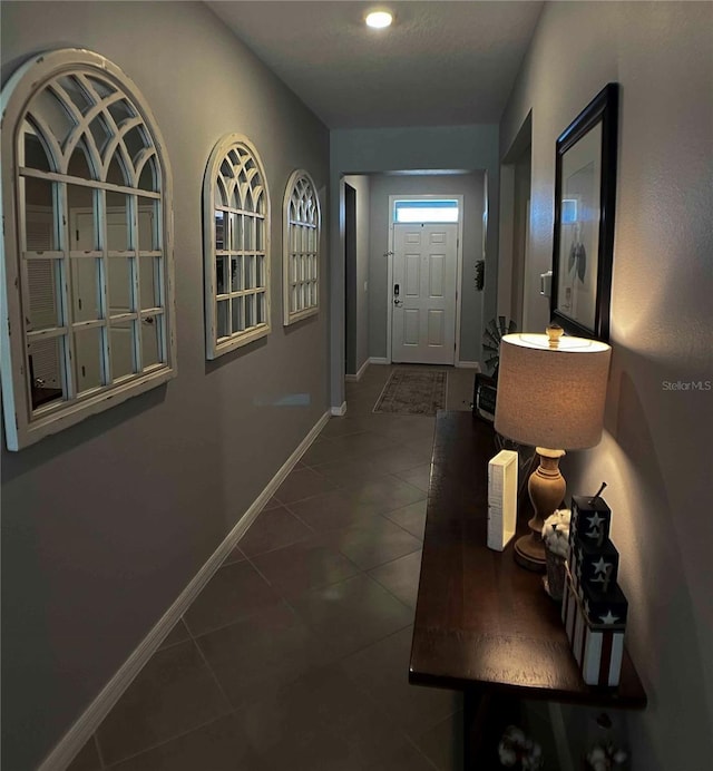 doorway featuring dark tile patterned floors