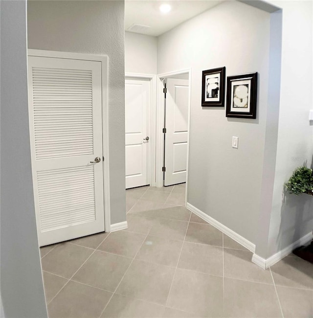 hall featuring light tile patterned flooring