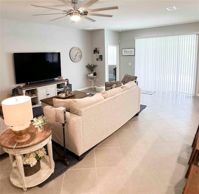 tiled living room with ceiling fan