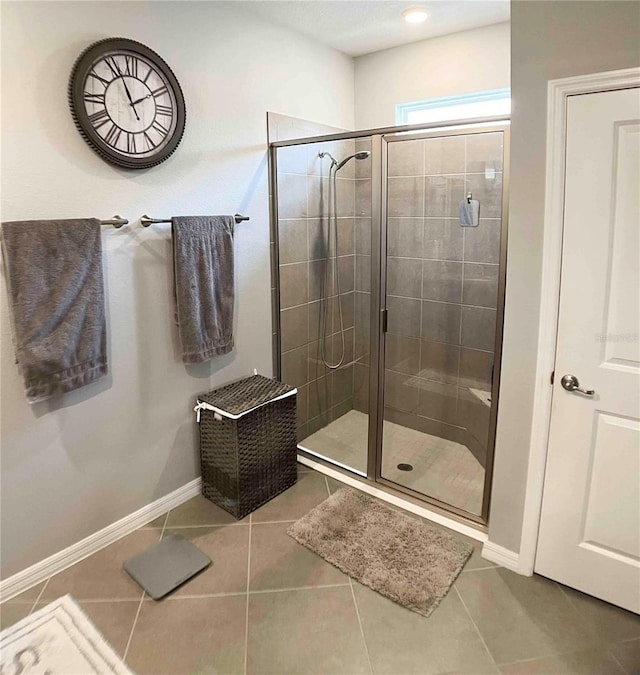 bathroom with tile patterned flooring and walk in shower