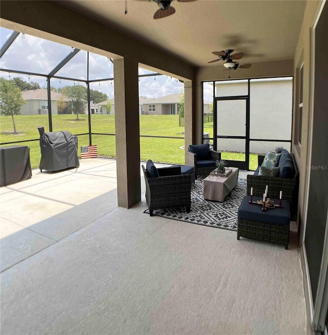 sunroom featuring ceiling fan