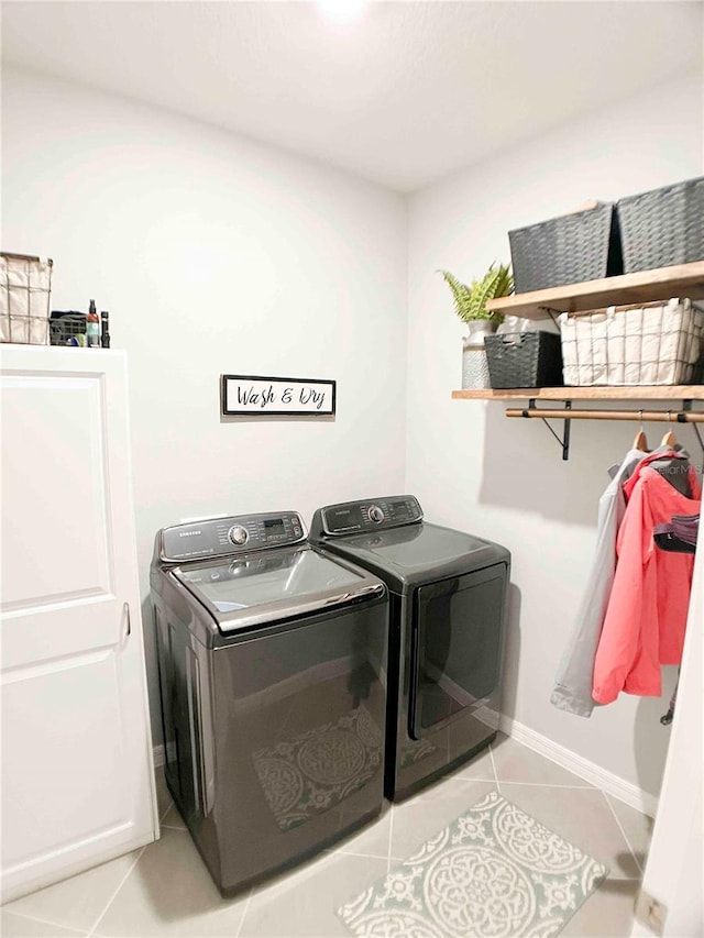 laundry room with light tile patterned flooring and independent washer and dryer