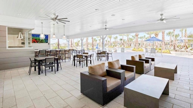 view of patio with ceiling fan, an outdoor bar, and an outdoor hangout area