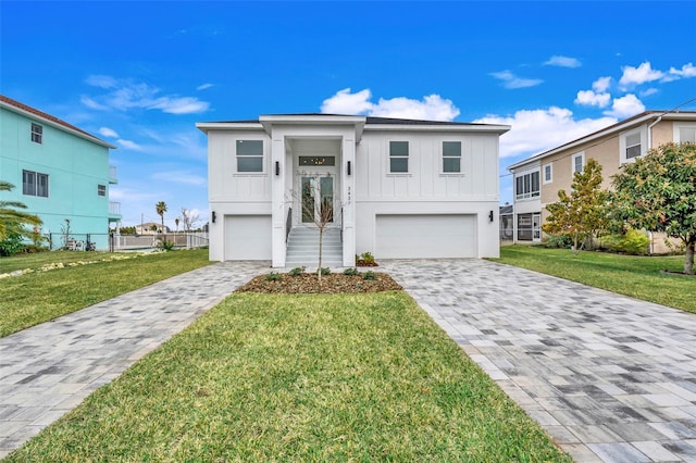 bi-level home featuring a garage and a front yard