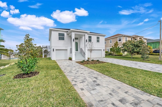 view of front of property featuring a garage and a front lawn