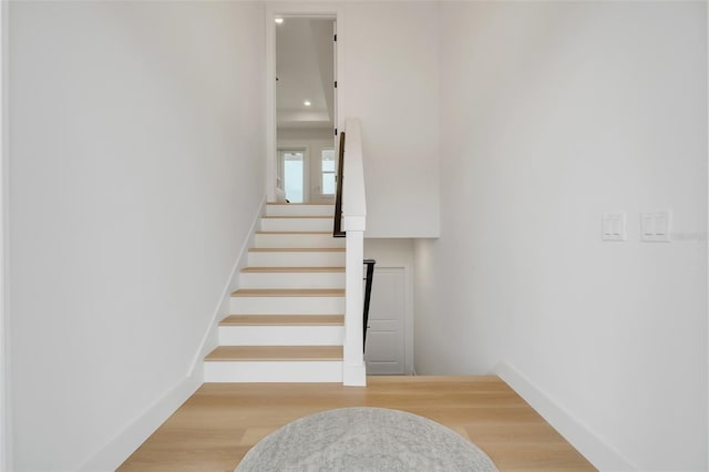 staircase featuring wood-type flooring