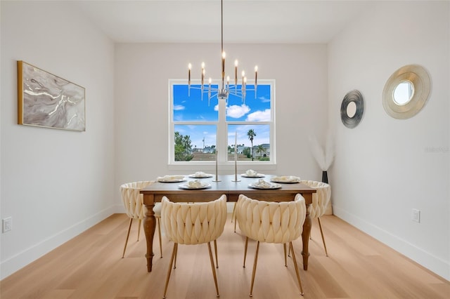 dining room with a chandelier and light wood-type flooring