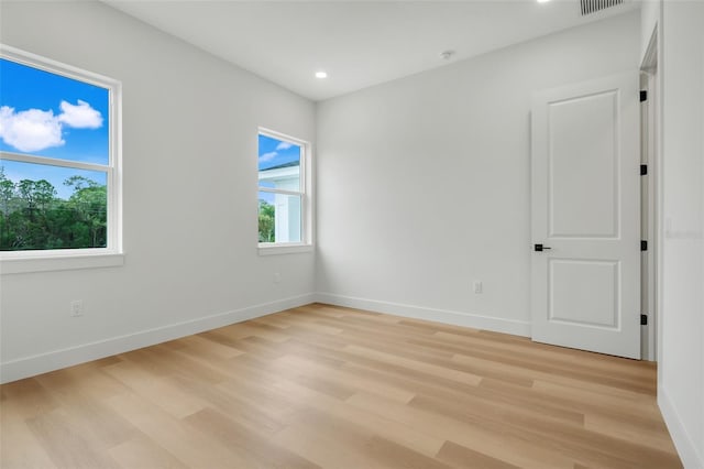 spare room featuring light hardwood / wood-style floors