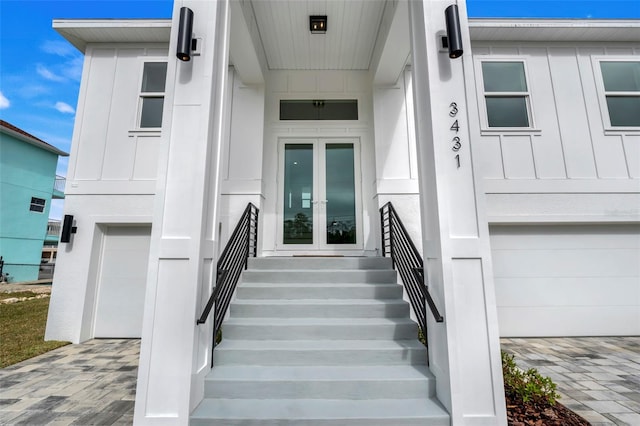 doorway to property with french doors and a garage