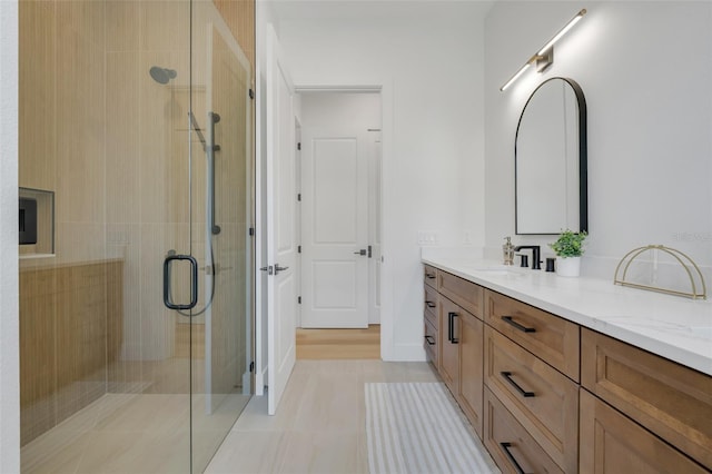 bathroom featuring vanity, an enclosed shower, and tile patterned floors