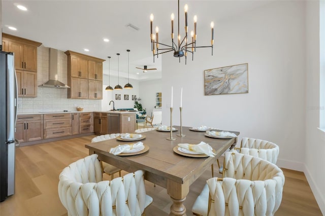 dining space with sink and light hardwood / wood-style floors