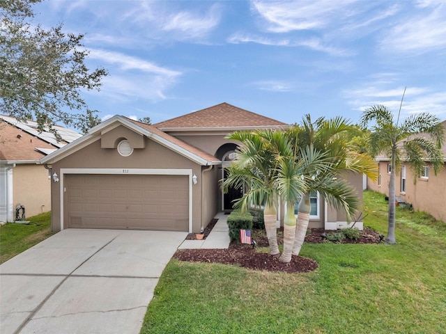 view of front of house featuring a garage and a front yard