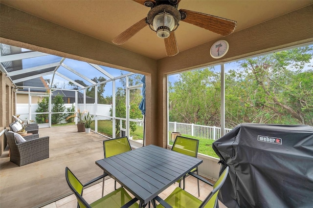 sunroom / solarium featuring vaulted ceiling, ceiling fan, and a wealth of natural light