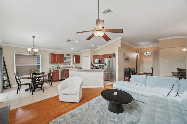 living room with light hardwood / wood-style floors, sink, ornamental molding, and ceiling fan with notable chandelier