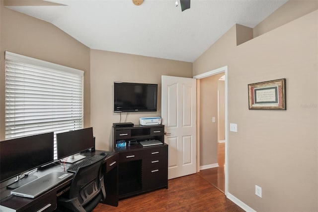 home office with lofted ceiling and dark hardwood / wood-style flooring