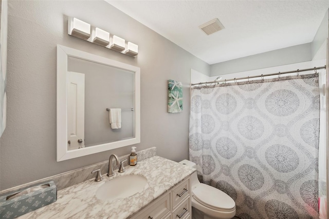 bathroom with vanity, toilet, and a shower with curtain