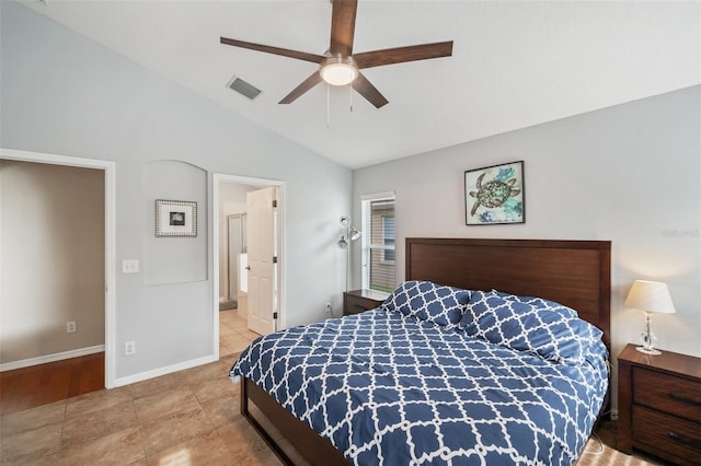 bedroom featuring tile patterned flooring, vaulted ceiling, ceiling fan, and connected bathroom