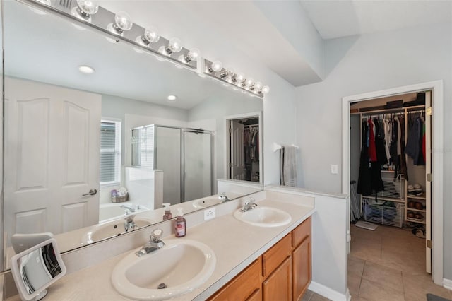 bathroom with tile patterned flooring, vanity, and plus walk in shower