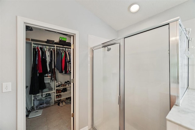 bathroom featuring vaulted ceiling and a shower with door