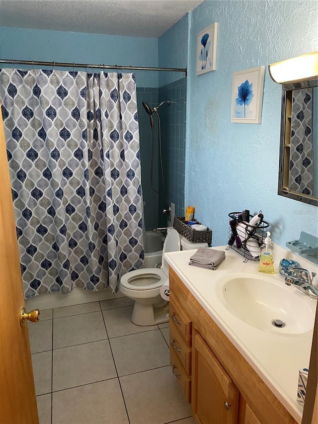 full bathroom featuring toilet, vanity, tile patterned floors, a textured ceiling, and shower / tub combo with curtain