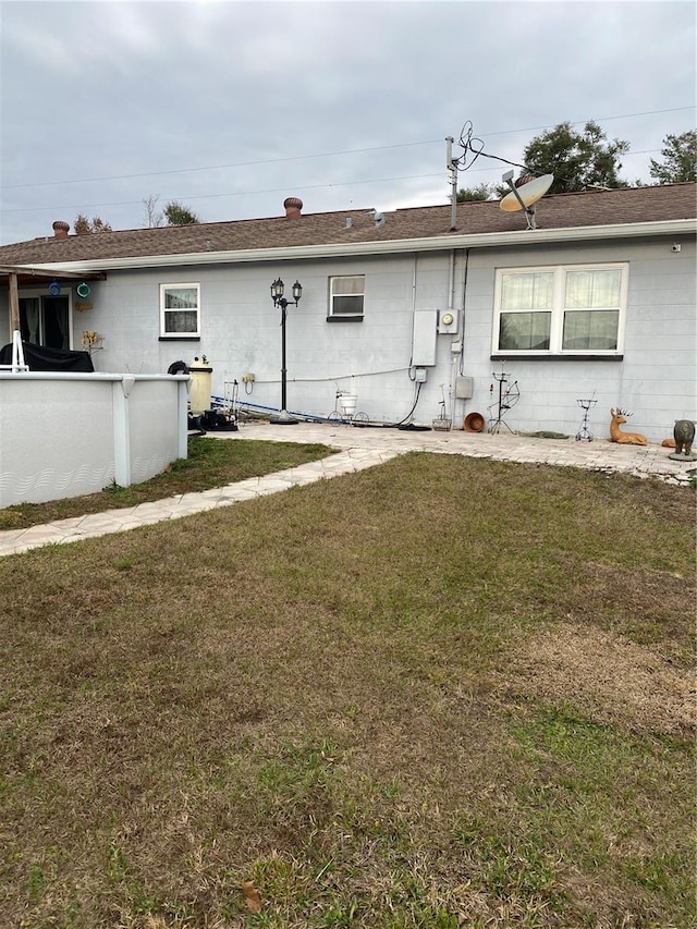 rear view of house with a yard