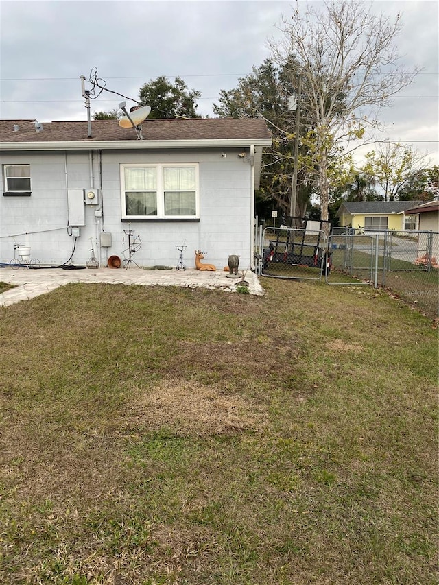 rear view of house featuring a yard